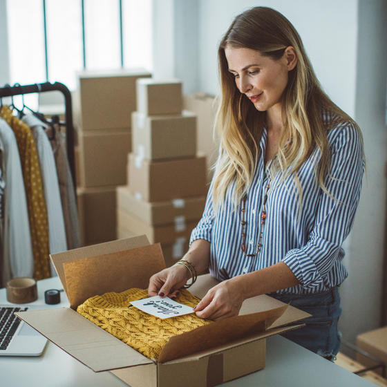 woman packing a box for shipment