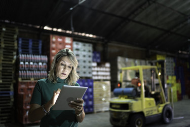 woman working on tablet in warehouse