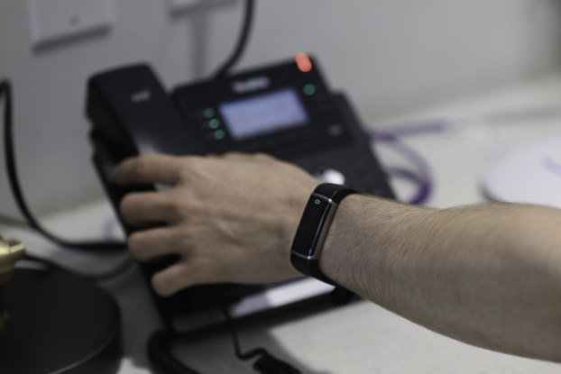 person wearing social distancing wristband by K2