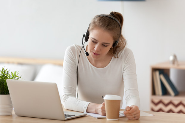 woman on laptop with headphones