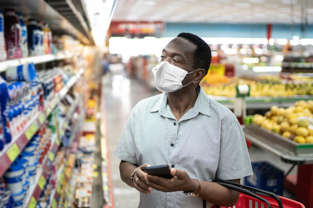 man shopping in supermarket with mask on