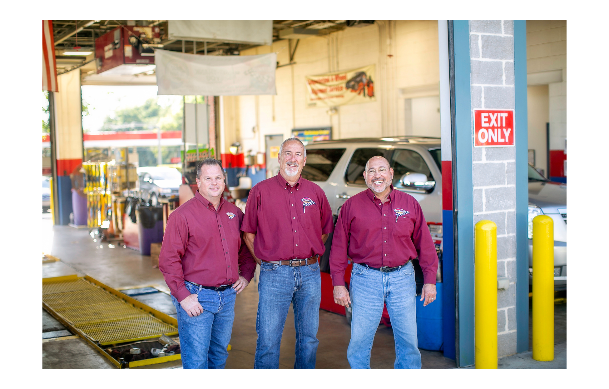 Group photo of the three owners of Dynamic Automotive inside one of their shops.