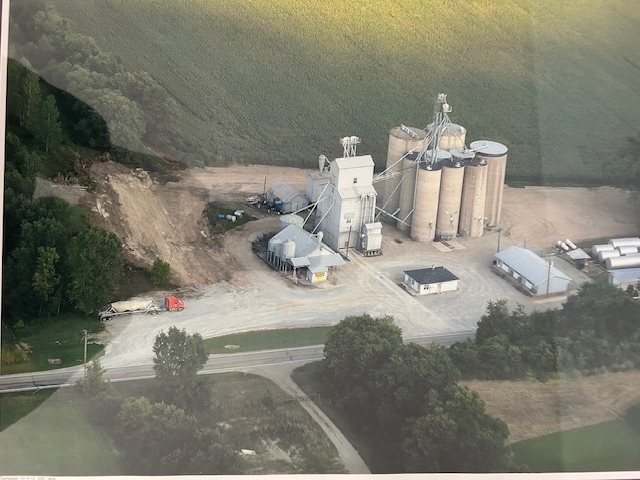 A large building with several silos, seen from above at a distance.