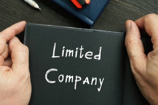 Hand holding a card with the text Limited Company