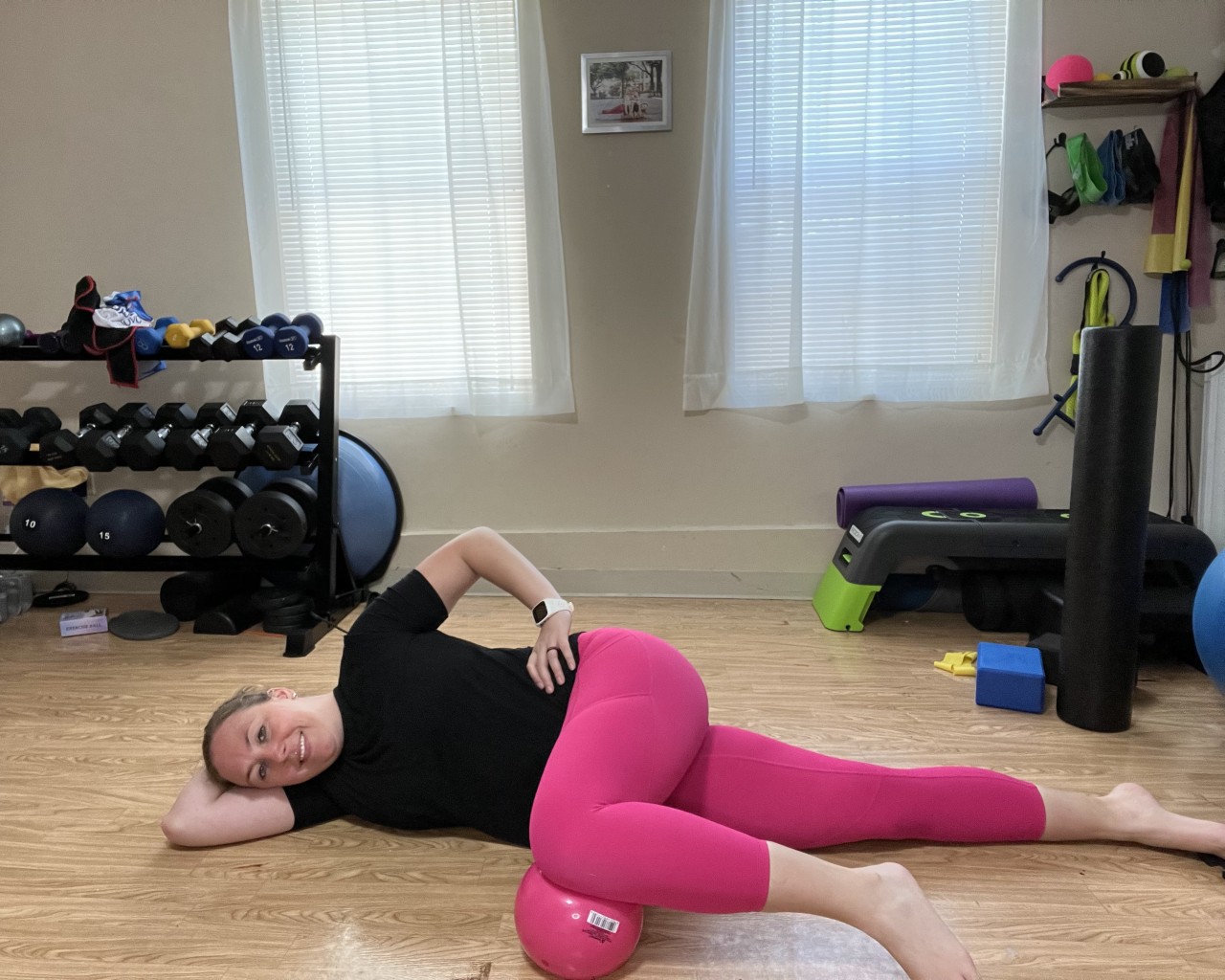 Jen of Moms Fit Life Showing a Side Lying Breathing Exercise