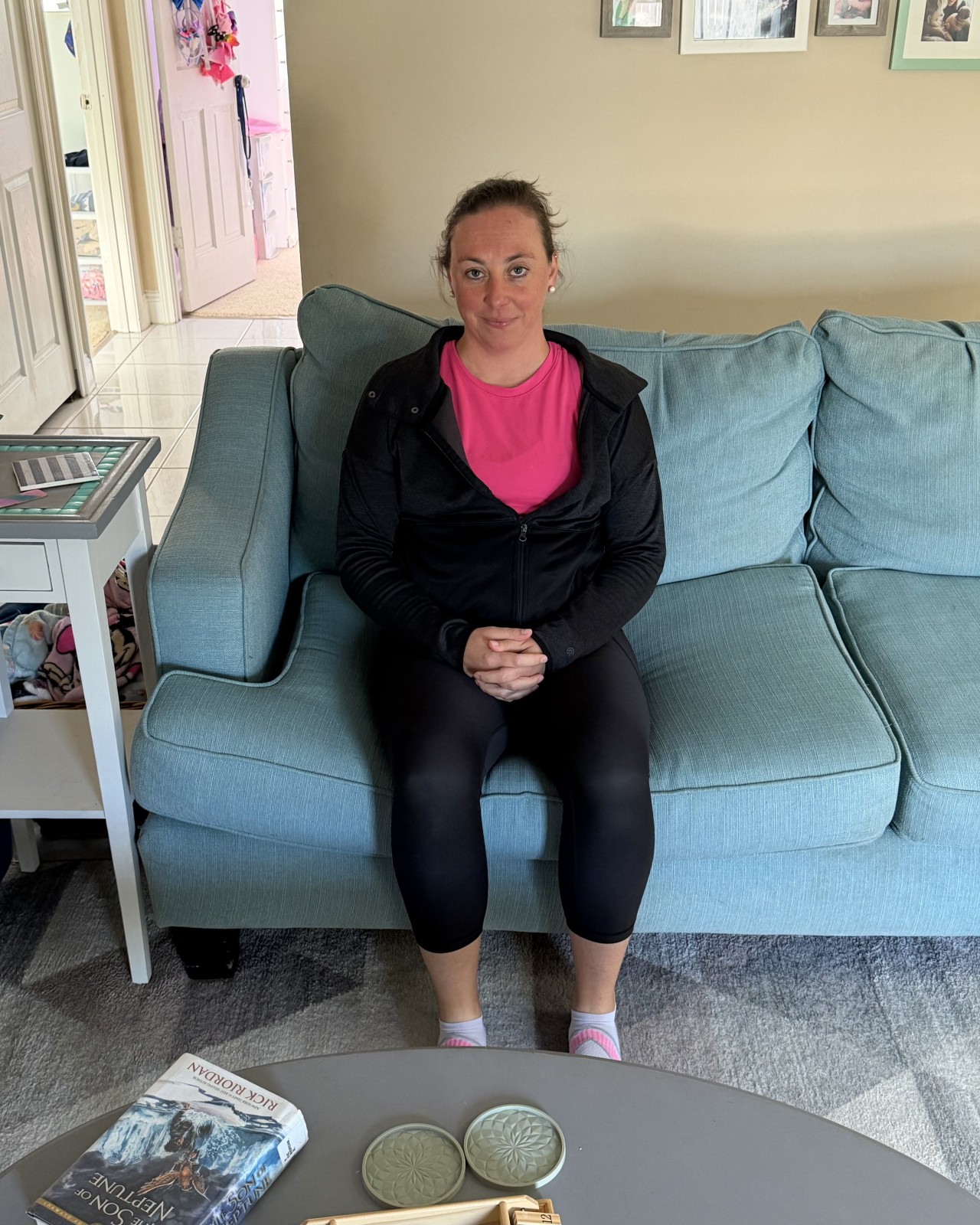 Jen of Moms Fit Life Sitting supported with pillows on the couch