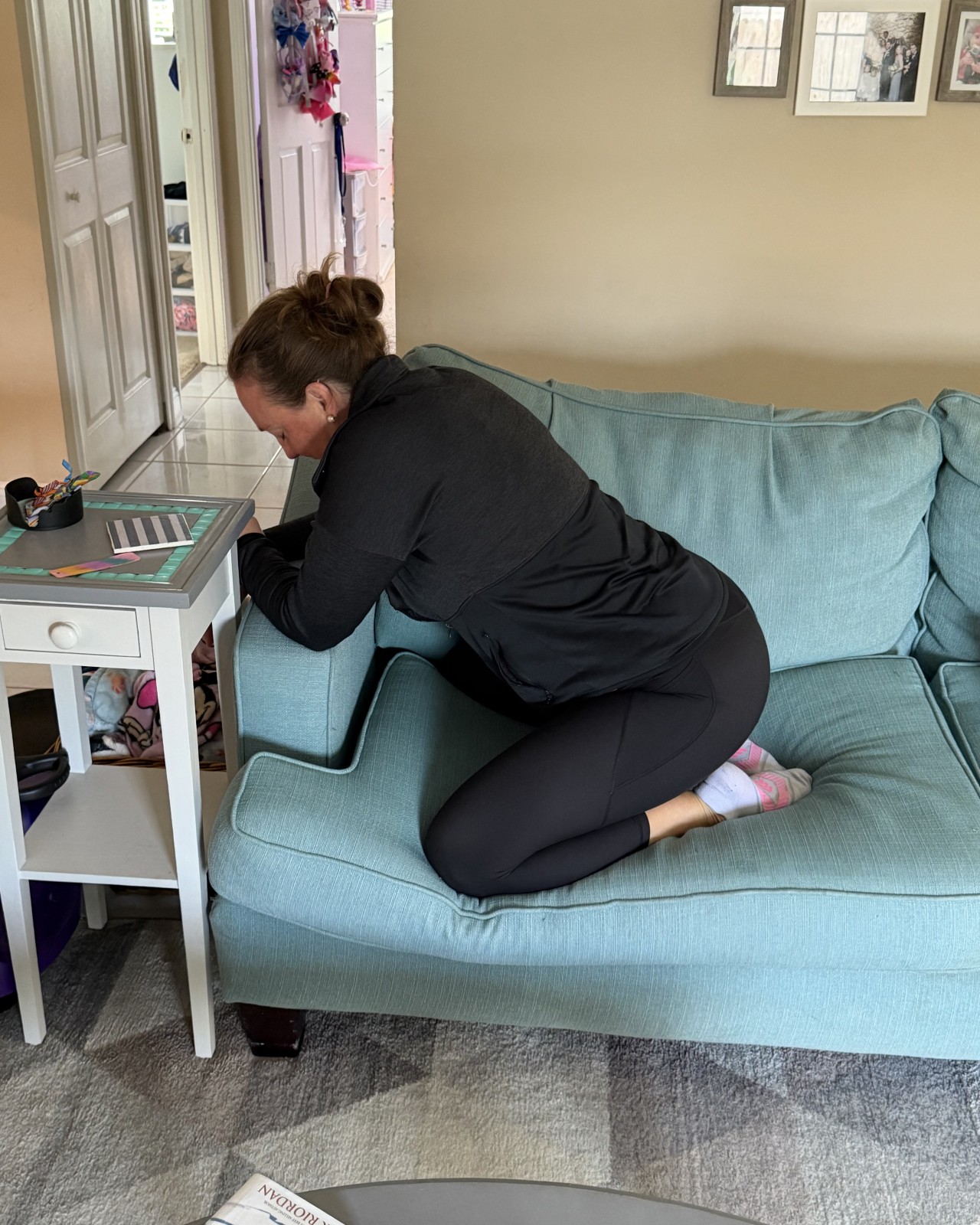 Jen of Moms Fit Life demostrating a different way to snack or read on the couch when preparing for labor