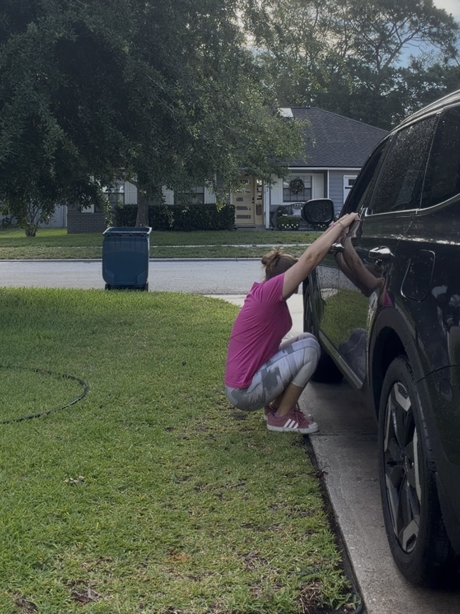 Jen Landry of Moms Fit Life showing a deep squat from her car