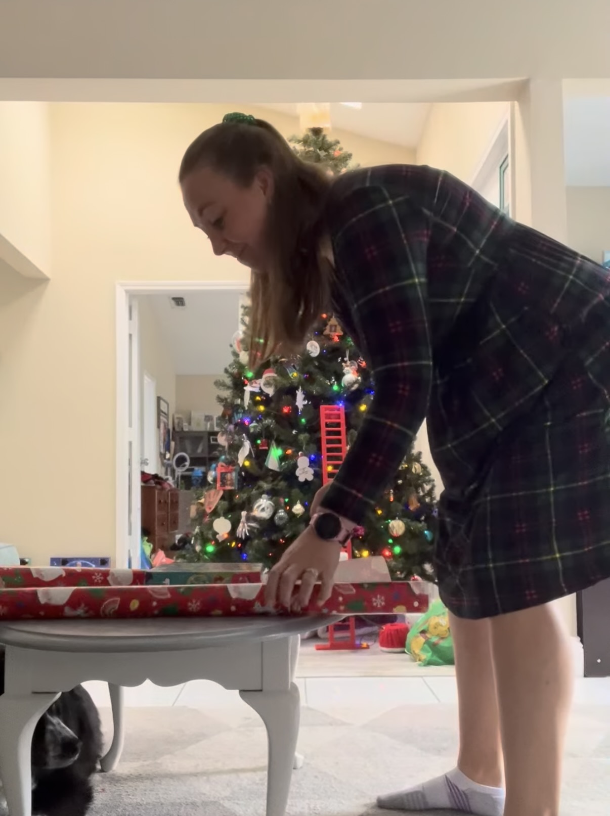 Mom wrapping presents at a short table