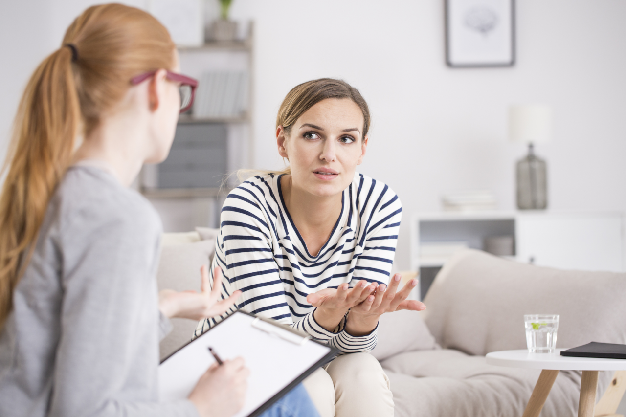 A person in a therapy session, receiving psychological treatment for their Irritable Bowel Syndrome (IBS) to manage symptoms and improve their well-being