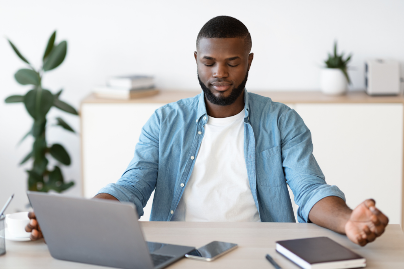 man meditating, clearing mind at work