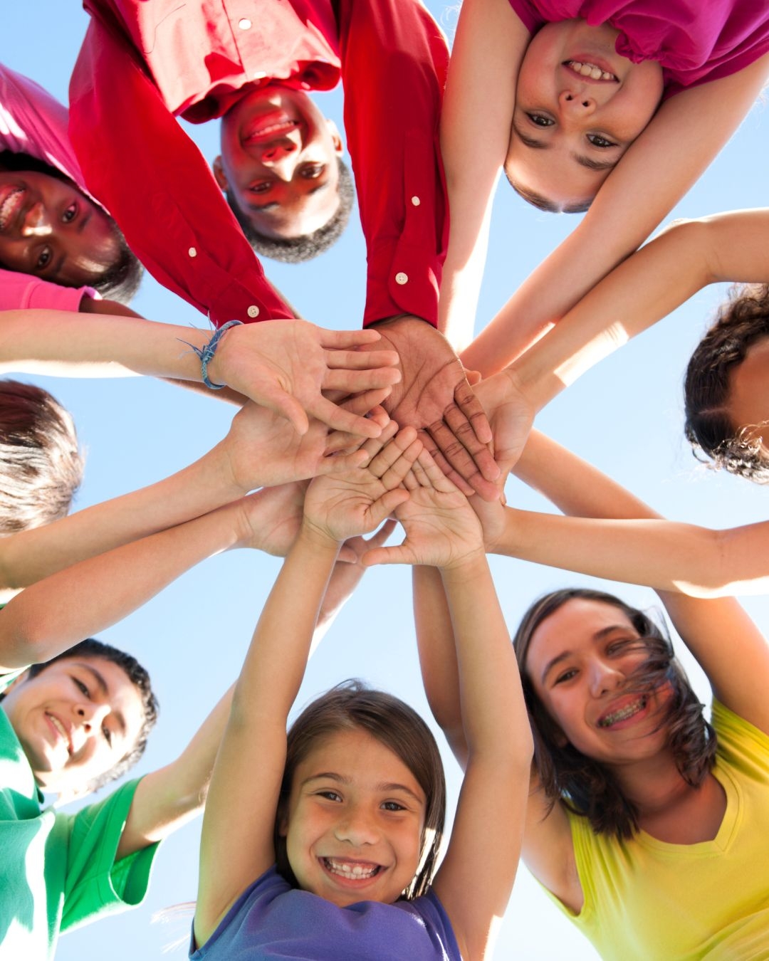 Annie Richardson smiling softly behind her raised hand, representing a gentle and relational psychotherapy approach.