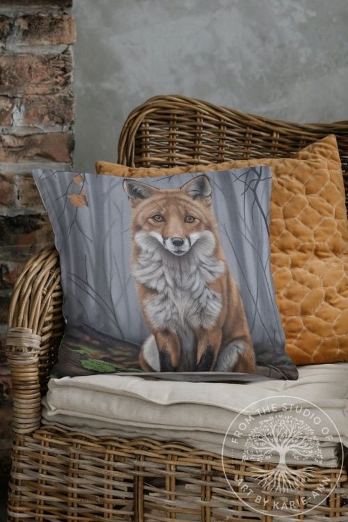 Decorative cushion with a red fox illustration surrounded by woodland foliage, wildlife art design.