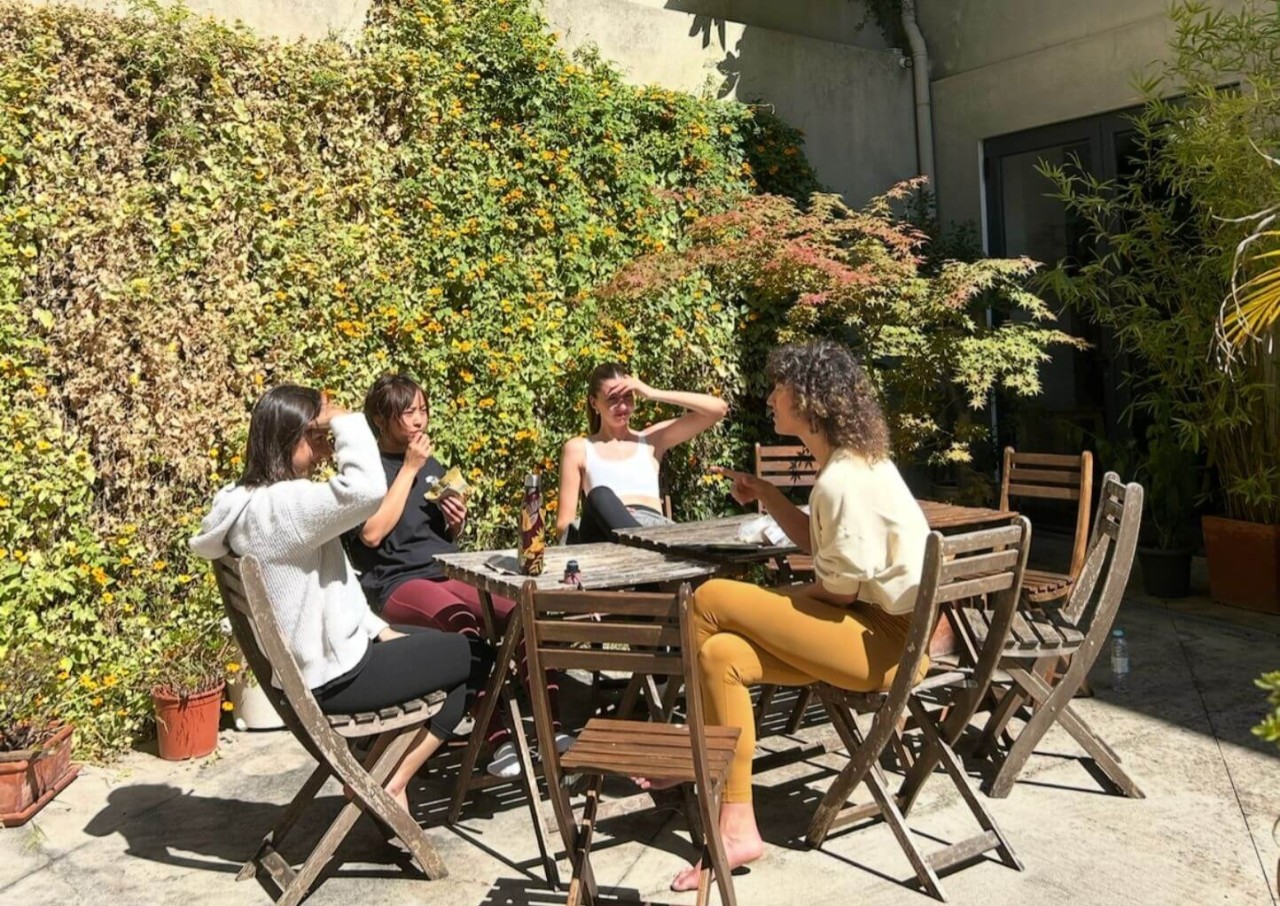 Power to Lead yoga teacher training students in courtyard at Jaya Aerial Lab in Lisbon, Portugal