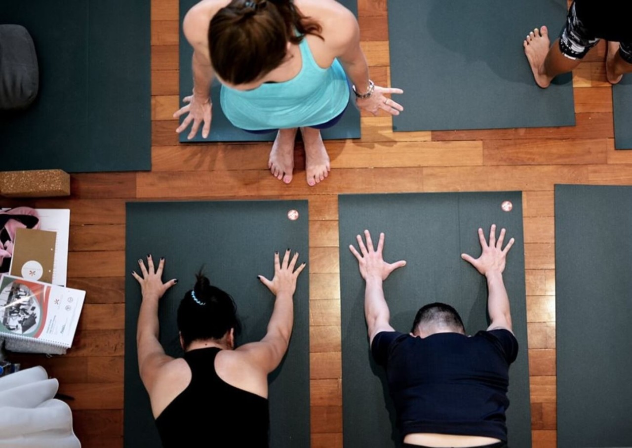 Students practice teaching with feedback during 200-hour yoga teacher training with Dr. Trish Corley