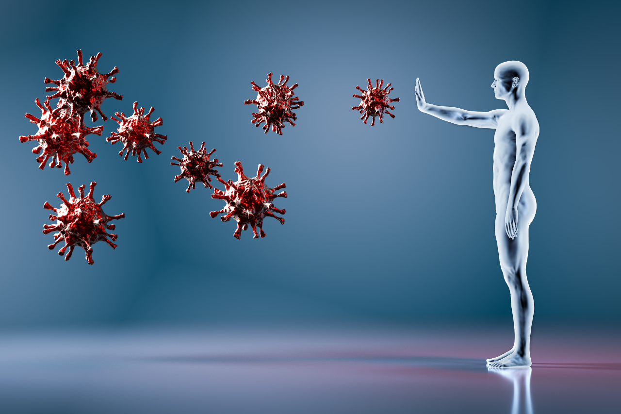 Silueta humana deteniendo virus, simbolizando la protección, resistencia y fortalecimiento del bienestar ante agentes externos.