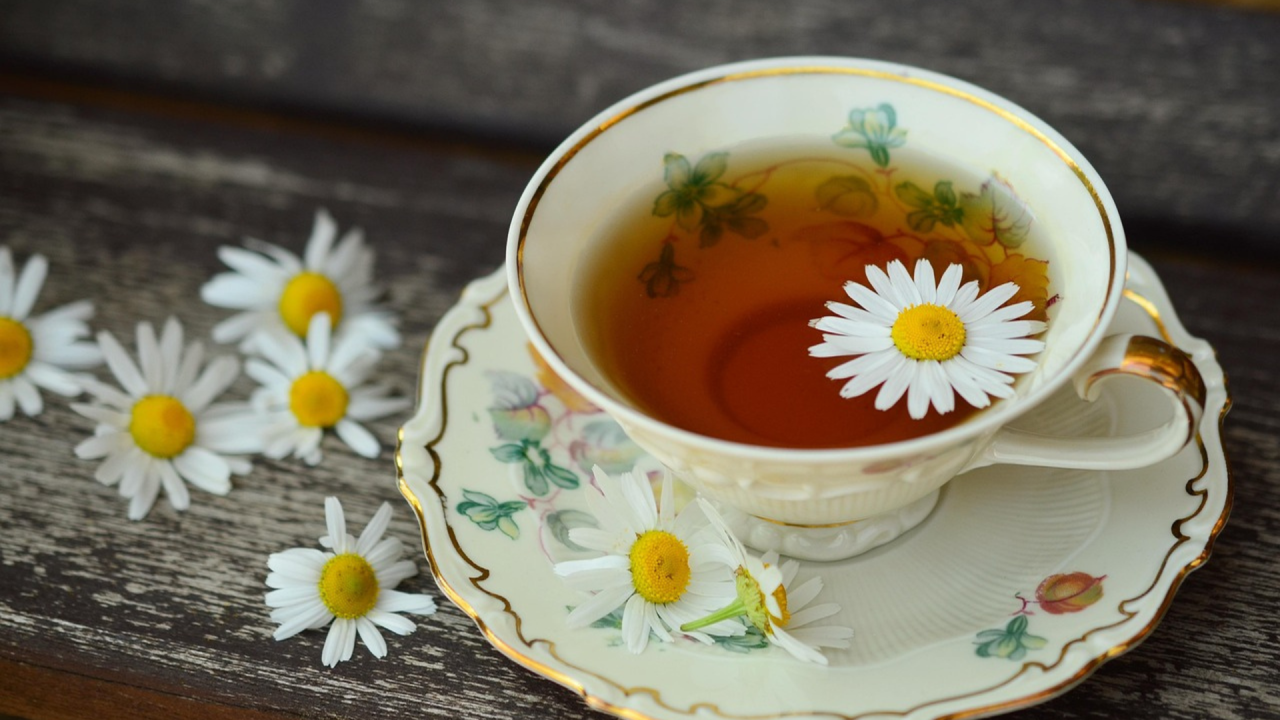 cup of tea surrounded by flowers
