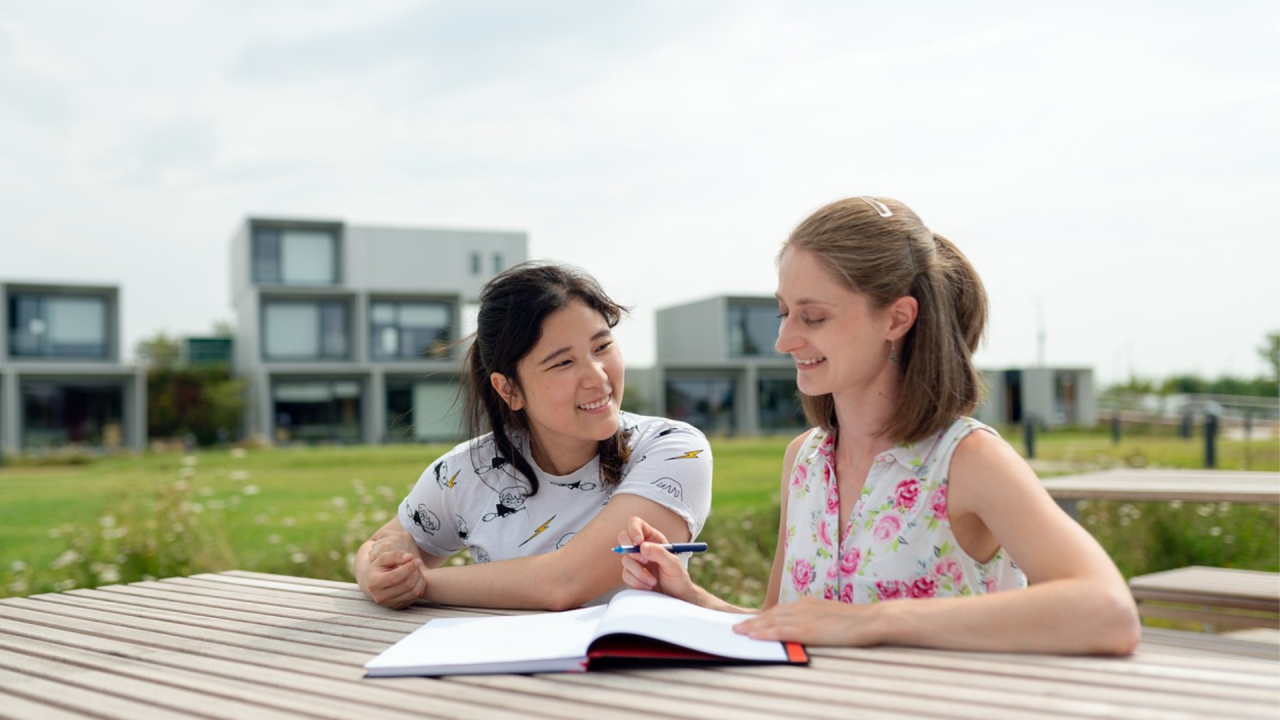 Two young women studying together