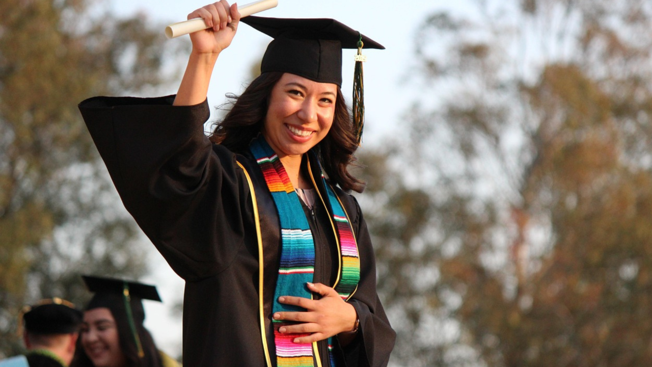 Smiling woman in university graduation clothes