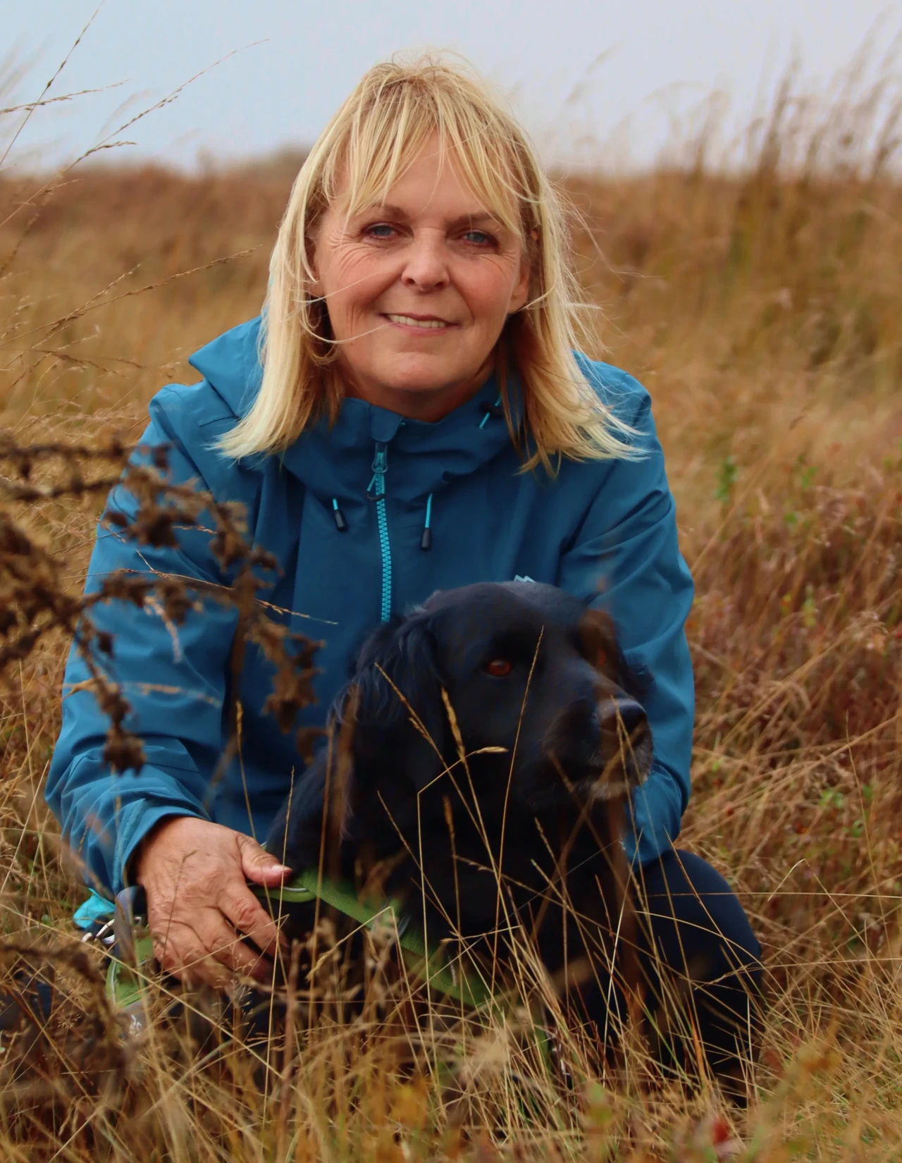 Victoria with black dog in field