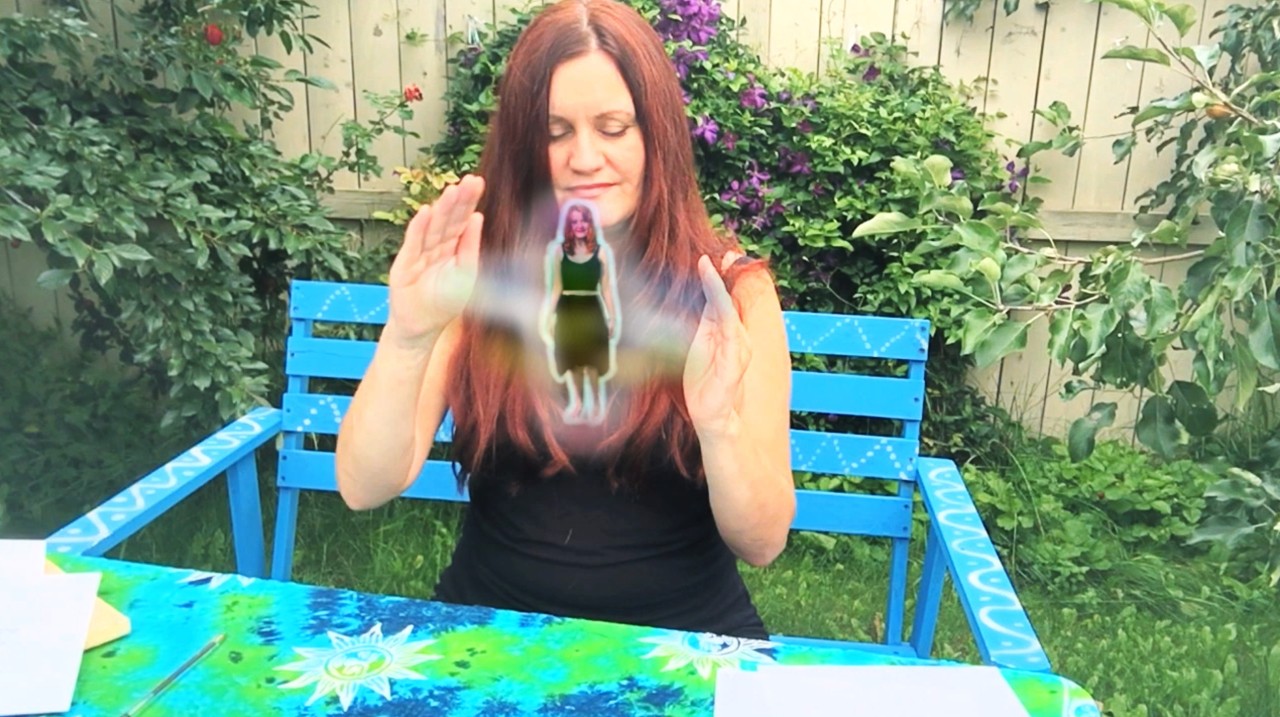 Daniela Reiki Master holding her palms together while sending distance Reiki