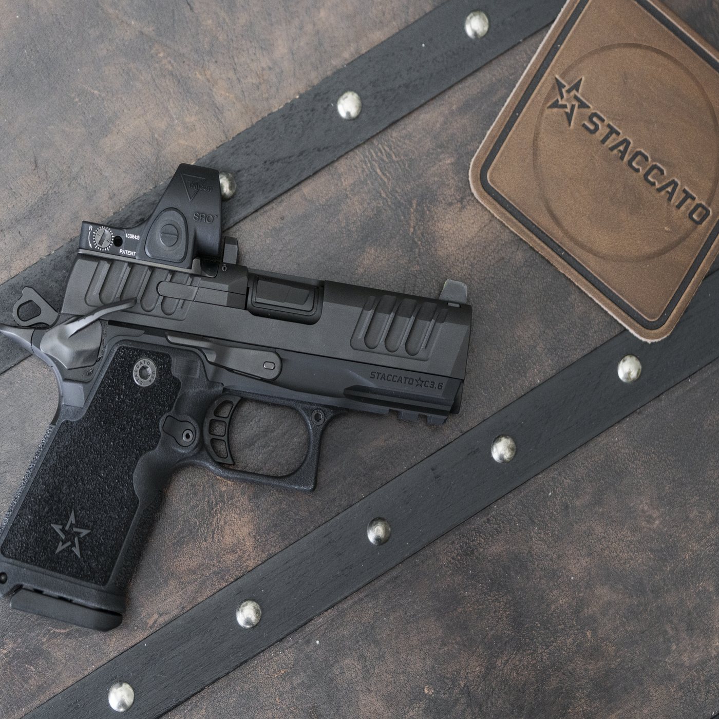 Staccato 2011 pistol with a red dot on a Staccato leather mat