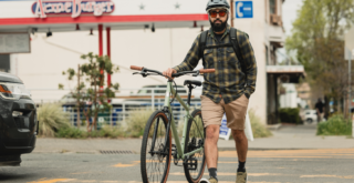 kentfield action shot, man walking with bike