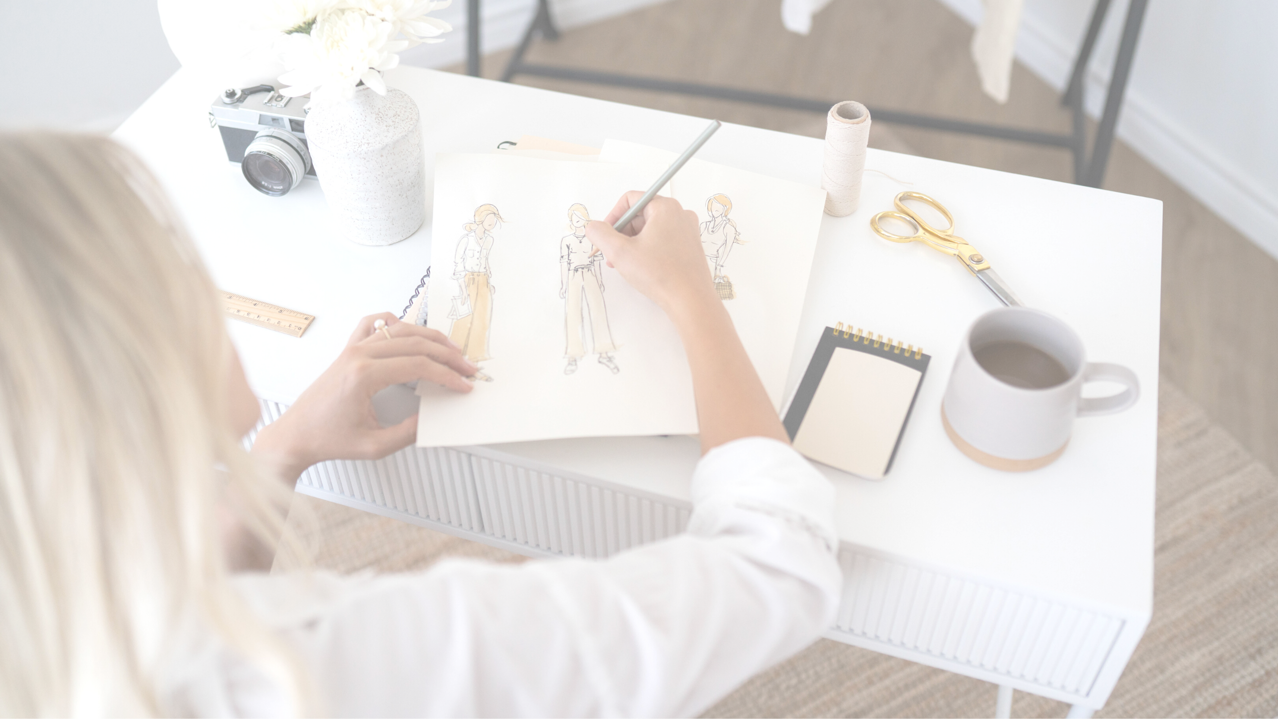 Designer sketching fashion looks at a desk