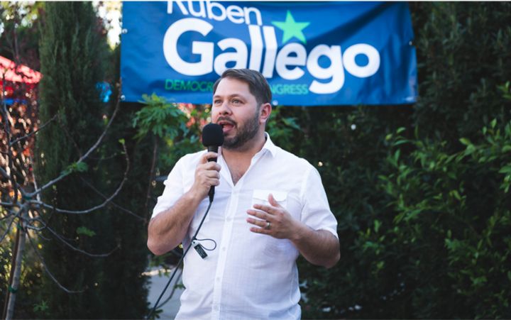 Image of Ruben Gallego speaking into a microphone at a campaign event Image of Ruben Gallego speaking into a microphone at a campaign event