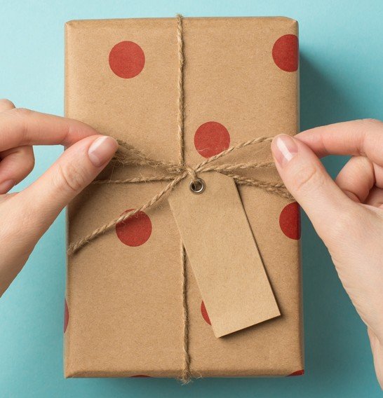 Red polka-dot gift box wrapped with twine ribbon