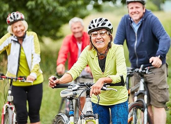 Four citizens out in nature enjoying a bike outing