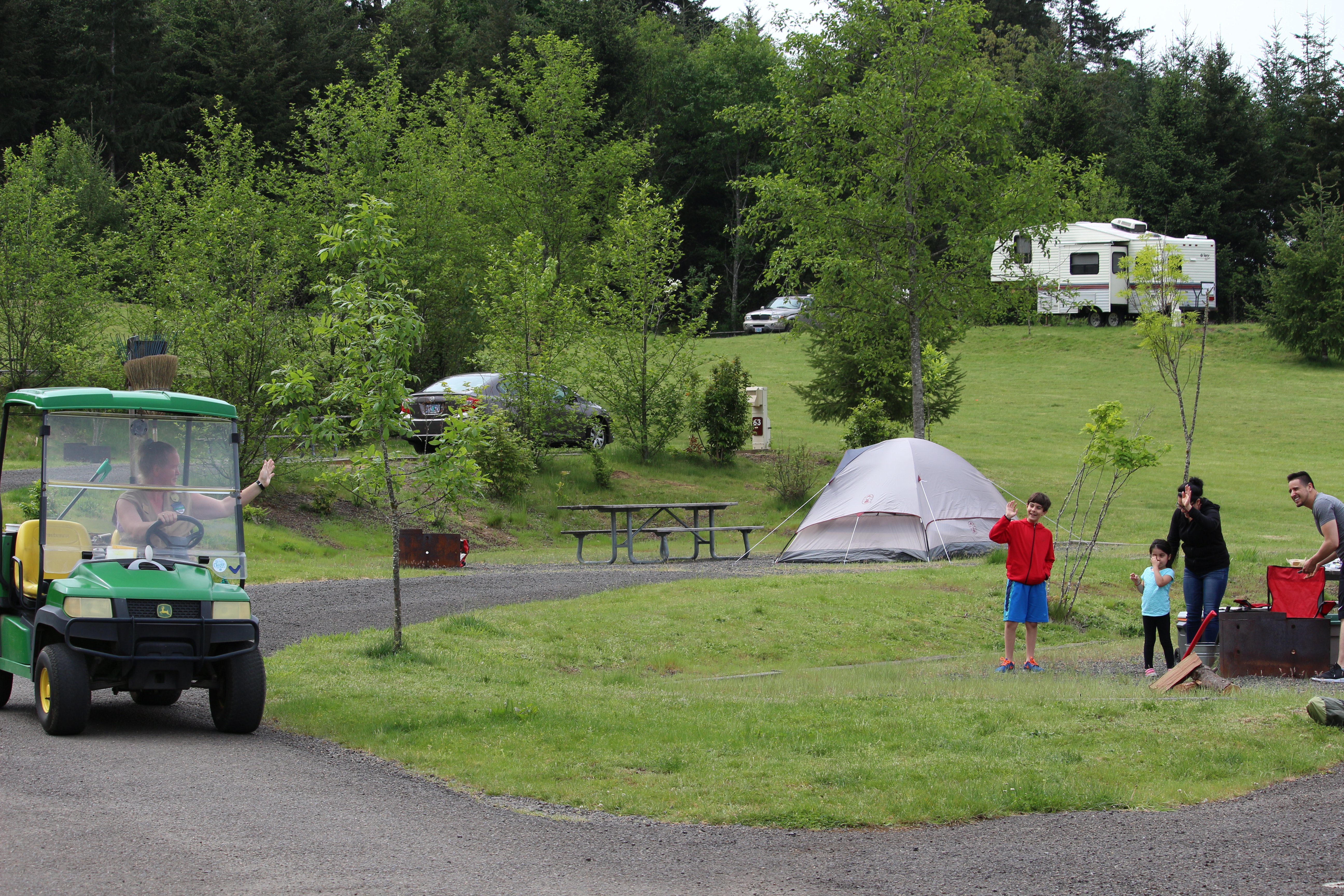 volunteer in a golf cart in the campgrouns