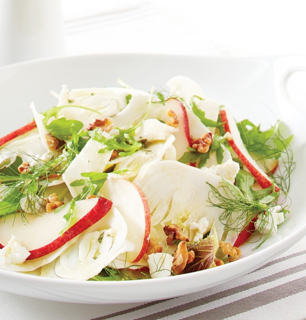 For this Pear-and-Fennel Salad, arrange baby Romaine and arugula leaves on a platter, topped with sliced red pears, thinly sliced fennel and crumbled goat cheese. Toast chopped walnuts in a skillet and toss onto greens.