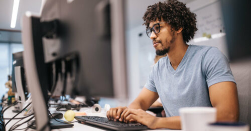 Man staring at computer wide