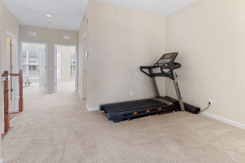 Workout area featuring light colored carpet