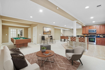 Interior space with light colored carpet, french doors, pool table, decorative columns, and ornamental molding