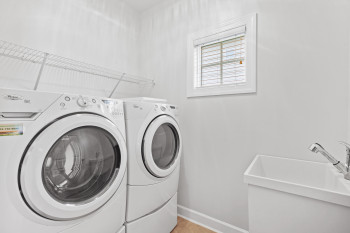 Laundry area with washing machine and dryer and sink
