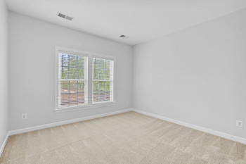 Empty room featuring light colored carpet