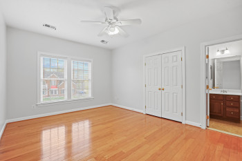 Unfurnished bedroom with ensuite bath, light hardwood / wood-style flooring, ceiling fan, and sink