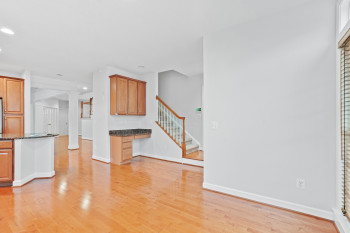 Unfurnished living room with light hardwood / wood-style flooring and ornate columns