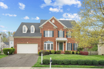 View of front facade with a garage and a front lawn