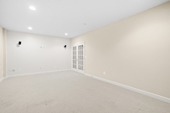 Empty room with light colored carpet