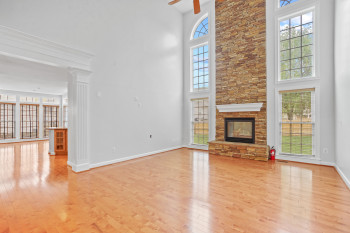 Unfurnished living room with plenty of natural light, a fireplace, and hardwood / wood-style flooring
