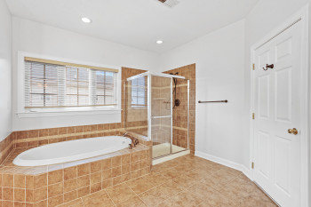 Bathroom with tile flooring and independent shower and bath