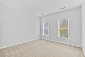 Empty room with light colored carpet
