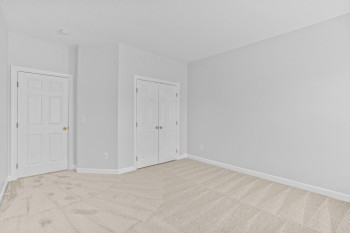 Unfurnished bedroom featuring light colored carpet and a closet