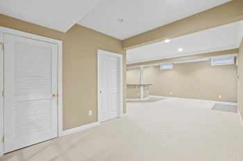 Basement featuring light colored carpet