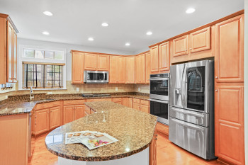Kitchen with a kitchen island, stainless steel appliances, and backsplash