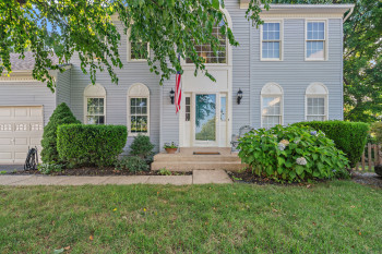 View of front of house featuring a garage and a front yard