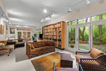 Living room with rail lighting and carpet